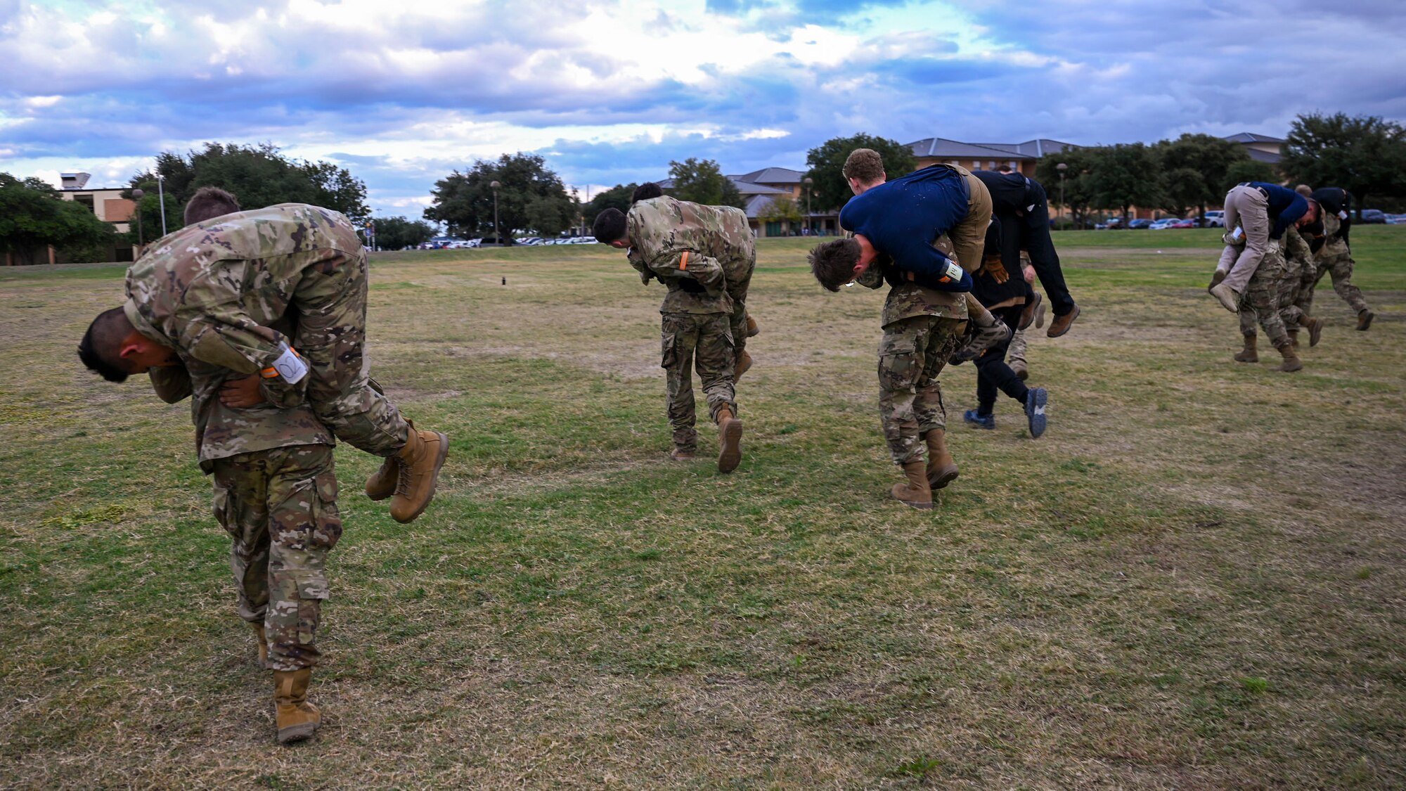 U.S. Air Force Reserve Officer Training Corps cadets from eleven universities complete fireman carries during the Special Warfare Air Force Reserve Officer Training Corps Weekend at the Angelo State University band field, San Angelo, Texas, Oct. 19, 2024. Cadets competed in events that tested their readiness knowledge, problem-solving skills, physical fitness, communication, memorization, land navigation, medical evacuation and mental capabilities under stressed conditions. (U.S. Air Force photo by Airman 1st Class Evelyn J. D’Errico)