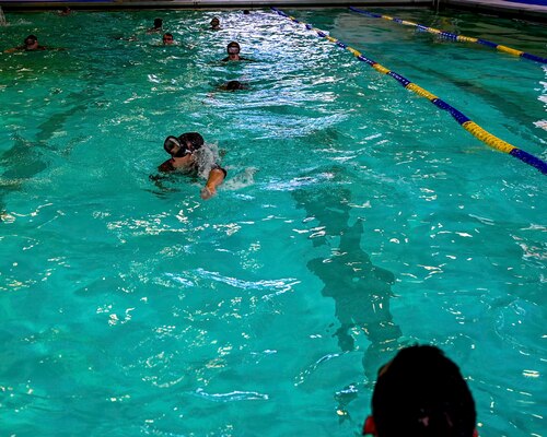 U.S. Air Force Reserve Officer Training Corps cadets from eleven different universities swim back during “underwaters” during the Pool Academics of the Special Warfare Air Force Reserve Officer Training Corp Weekend at Ben Kelly Center for Human Performance pool, Angelo State University, San Angelo, Texas, Oct. 19, 2024. Cadets competed in events that tested their readiness knowledge, problem-solving skills, physical fitness, communication, memorization, land navigation, medical evacuation and mental capabilities under stressed conditions. (U.S. Air Force photo by Airman 1st Class Evelyn J. D’Errico)