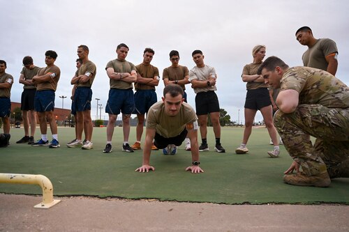 U.S. Air Force Maj. Eric Atchinson, Special Warfare Recruiting officer, instructs USAF Reserve Officer Training Corps cadets from eleven different universities on proper push-up form during the Special Warfare Air Force Reserve Officer Training Corps Weekend at the Mathis Gym, Goodfellow Air Force Base, Texas, Oct. 19, 2024. Cadets competed in events that tested their readiness knowledge, problem-solving skills, physical fitness, communication, memorization, land navigation, medical evacuation and mental capabilities under stressed conditions. (U.S. Air Force photo by Airman 1st Class Evelyn J. D’Errico)