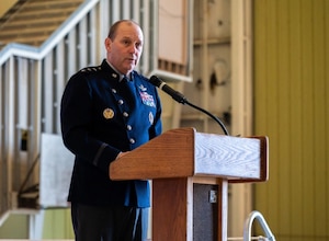 Military officer in uniform speaking at a podeum