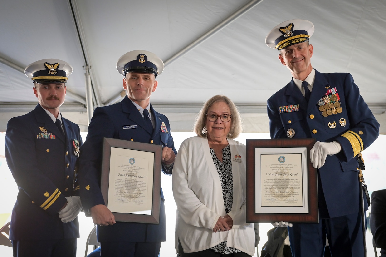 Lt. Connor Ives, Commanding Officer of Coast Guard Cutter Florence Finch (WPC 1157), Master Chief Kody Fraughton and Adm. Charles Fosse, 13th District Commander, present Betty Murphy with a plaque after her mother, Florence Finch, was made an honorary Chief Petty Officer during a commissioning ceremony in Seattle