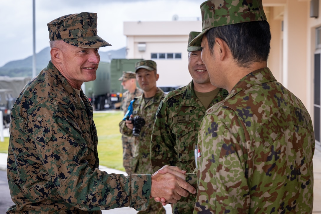 U.S. Marine Corps Lt. Gen. Roger B. Turner, left, commanding general of III Marine Expeditionary Force, greets Japan Ground Self-Defense Force members during exercise Keen Sword 25 at JGSDF Camp Ishigaki, Okinawa, Japan, Oct. 23, 2024. KS25 is a biennial, joint and bilateral field-training exercise involving U.S. military and Japan Self-Defense Force personnel, designed to increase readiness and interoperability while strengthening the ironclad U.S.-Japan alliance. (U.S. Marine Corps photo by Staff Sgt. JVonnta Taylor)