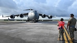 From left: Airman 1st Class Ayreona Nickson , 734th Air Mobility Squadron passenger service representative, directs the pilot of a C-17 Globemaster to a stop while Staff Sgt. Jarom Johnston, 734th AMS aircraft electrical systems craftsman, monitor and guides her at Andersen Air Force Base, Guam, Oct. 23, 2024. While performing disaggregated operations under Slingstone 24-4, the 734th AMS team capitalize on the opportunity to teach 734th AMS Airmen on how to perform different jobs. (U.S. Air Force photo by Senior Airman Akeem K. Campbell)