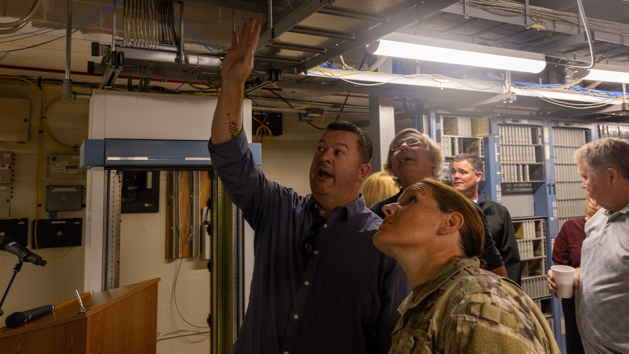 man tours group through server room