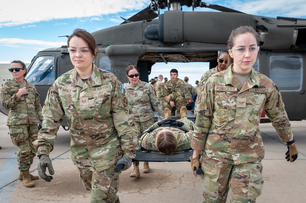 944th Fighter Wing Reserve Citizen Airmen carry a simulated patient onto a UH-60 Black Hawk helicopter during medevac training at Goodyear Phoenix Airport, Goodyear, Ariz., Oct. 19, 2024. The exercise, conducted with Arizona Army National Guard personnel, prepares both units for the large-scale Exercise Desert Hammer 25-1 in November. (U.S. Air Force photo by Senior Airman Alexis Orozco)