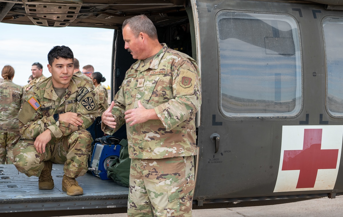 944th Fighter Wing Reserve Citizen Airmen and Arizona Army National Guard personnel discuss patient transport procedures inside a UH-60 Black Hawk helicopter during joint medevac training at Goodyear Phoenix Airport, Goodyear, Ariz., Oct. 19, 2024. This training strengthens joint capabilities ahead of Exercise Desert Hammer 25-1 in November. (U.S. Air Force photo by Senior Airman Alexis Orozco)