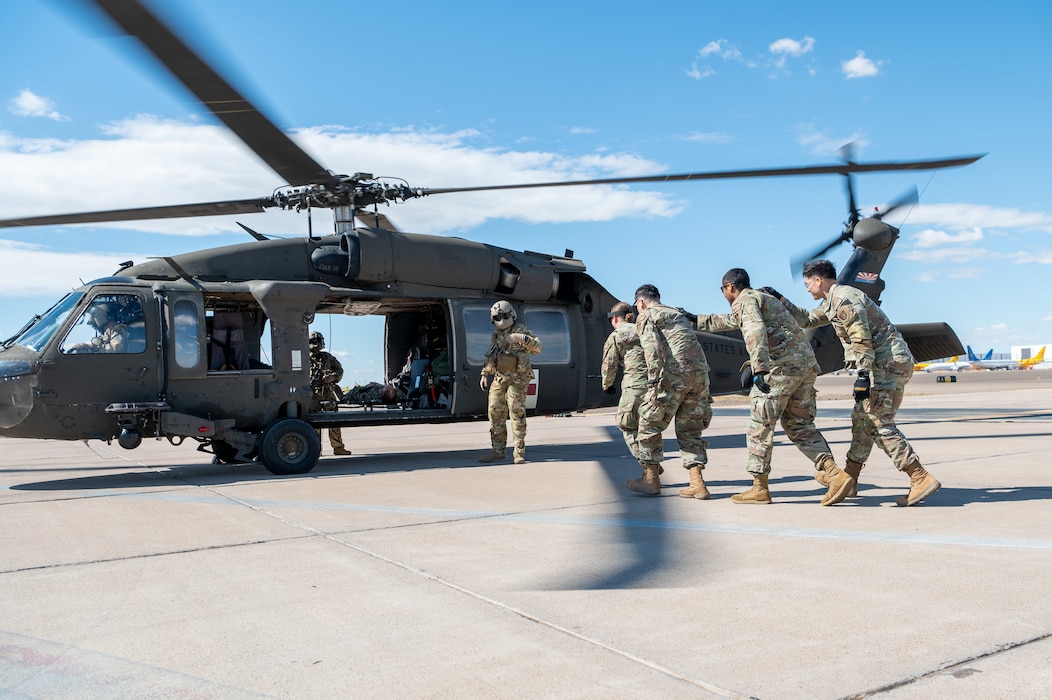 944th Fighter Wing Reserve Citizen Airmen and Arizona Army National Guard personnel prepare to load a simulated patient into a UH-60 Black Hawk helicopter during medevac training at Goodyear Phoenix Airport, Goodyear, Ariz., Oct. 19, 2024. The joint exercise ensures readiness for upcoming missions such as Exercise Desert Hammer 25-1 in November. (U.S. Air Force photo by Senior Airman Alexis Orozco)