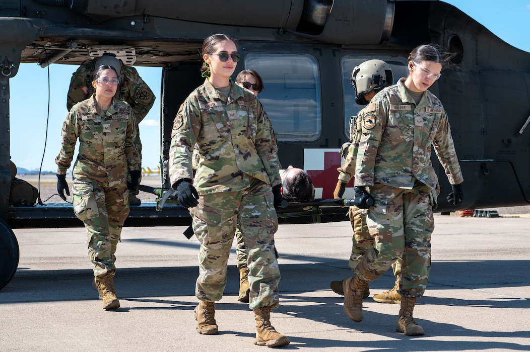 944th Fighter Wing Reserve Citizen Airmen carry a simulated patient from a UH-60 Black Hawk helicopter during medevac training at Goodyear Phoenix Airport, Goodyear, Ariz., Oct. 19, 2024. The exercise, conducted in conjunction with the Arizona Army National Guard, prepares for Exercise Desert Hammer 25-1 in November. (U.S. Air Force photo by Senior Airman Alexis Orozco)