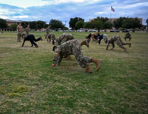 U.S. Air Force Reserve Officer Training Corps cadets from eleven universities complete one-legged bear crawls during the Special Warfare Air Force Reserve Officer Training Corps Weekend at the Angelo State University bandfield, San Angelo, Texas, Oct. 19, 2024. Cadets competed in events that tested their readiness knowledge, problem-solving skills, physical fitness, communication, memorization, land navigation, medical evacuation and mental capabilities under stressed conditions. (U.S. Air Force photo by Airman 1st Class Evelyn J. D’Errico)
