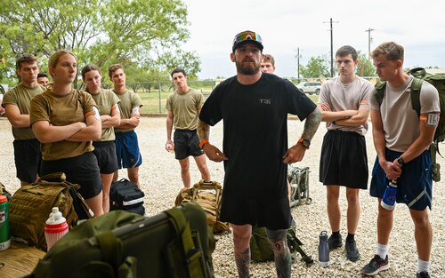 Reace Hudgeons, T3i Special Warfare Field Developer coach, briefs thirty-eight U.S. Air Force Reserve Officer Training Corps cadets from eleven universities in rucking fundamentals during the Special Warfare Air Force Reserve Officer Training Corps Weekend at Forward Operating Base Sentinel, Goodfellow Air Force Base, Texas, Oct. 19, 2024. Cadets competed in events that tested their readiness knowledge, problem-solving skills, physical fitness, communication, memorization, land navigation, medical evacuation and mental capabilities under stressed conditions. (U.S. Air Force photo by Airman 1st Class Evelyn J. D’Errico)