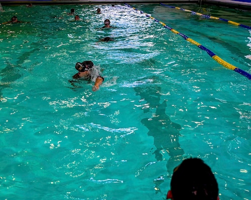 U.S. Air Force Reserve Officer Training Corps cadets from eleven different universities swim back during “underwaters” during the Pool Academics of the Special Warfare Air Force Reserve Officer Training Corp Weekend at Ben Kelly Center for Human Performance pool, Angelo State University, San Angelo, Texas, Oct. 19, 2024. Cadets competed in events that tested their readiness knowledge, problem-solving skills, physical fitness, communication, memorization, land navigation, medical evacuation and mental capabilities under stressed conditions. (U.S. Air Force photo by Airman 1st Class Evelyn J. D’Errico)
