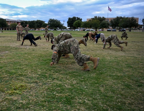 U.S. Air Force Reserve Officer Training Corps cadets from eleven universities complete one-legged bear crawls during the Special Warfare Air Force Reserve Officer Training Corps Weekend at the Angelo State University bandfield, San Angelo, Texas, Oct. 19, 2024. Cadets competed in events that tested their readiness knowledge, problem-solving skills, physical fitness, communication, memorization, land navigation, medical evacuation and mental capabilities under stressed conditions. (U.S. Air Force photo by Airman 1st Class Evelyn J. D’Errico)