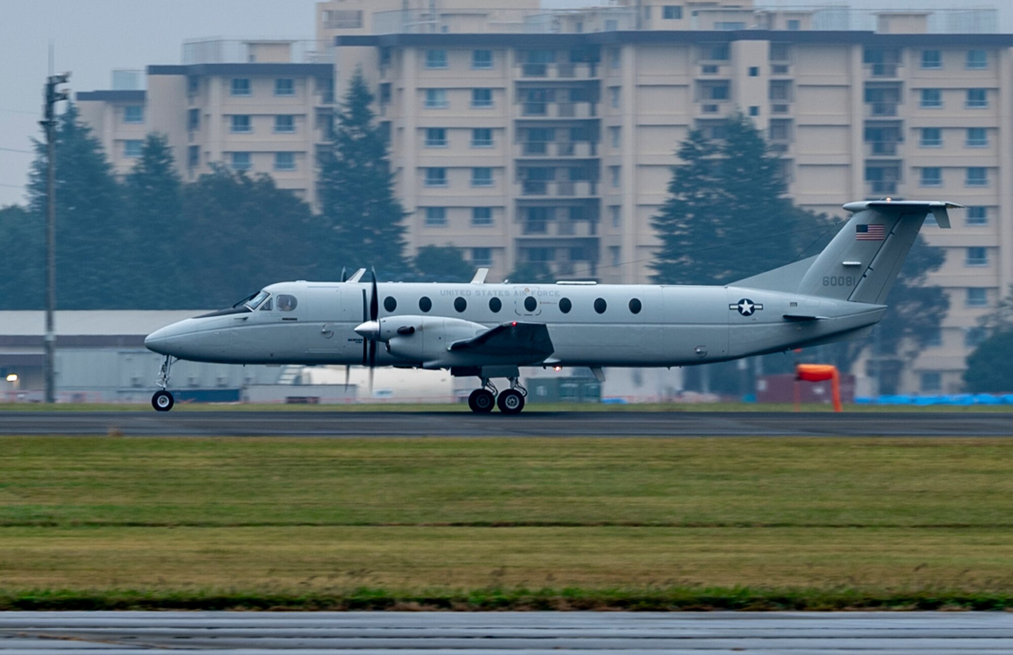 A C-12J aircraft takes off down the runway.