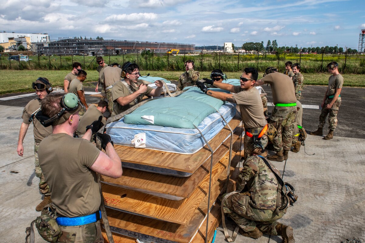 A group of people strapping pallets to the ground