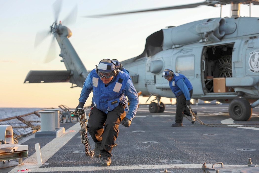 SN Gen Repatacodo removes the chains from an MH-60R Sea Hawk helicopter from HSM-79 aboard  USS Arleigh Burke (DDG 51).