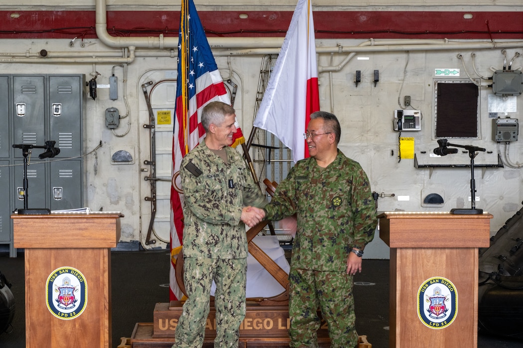 Adm. Steve Koehler, commander, U.S. Pacific Fleet, left, and Gen. Yoshida Yoshihide, chief of staff, Joint Staff, Japan Self-Defense Forces, shake hands at the conclusion of a press conference for Keen Sword 25 aboard the forward-deployed amphibious transport dock ship USS San Diego (LPD 22).