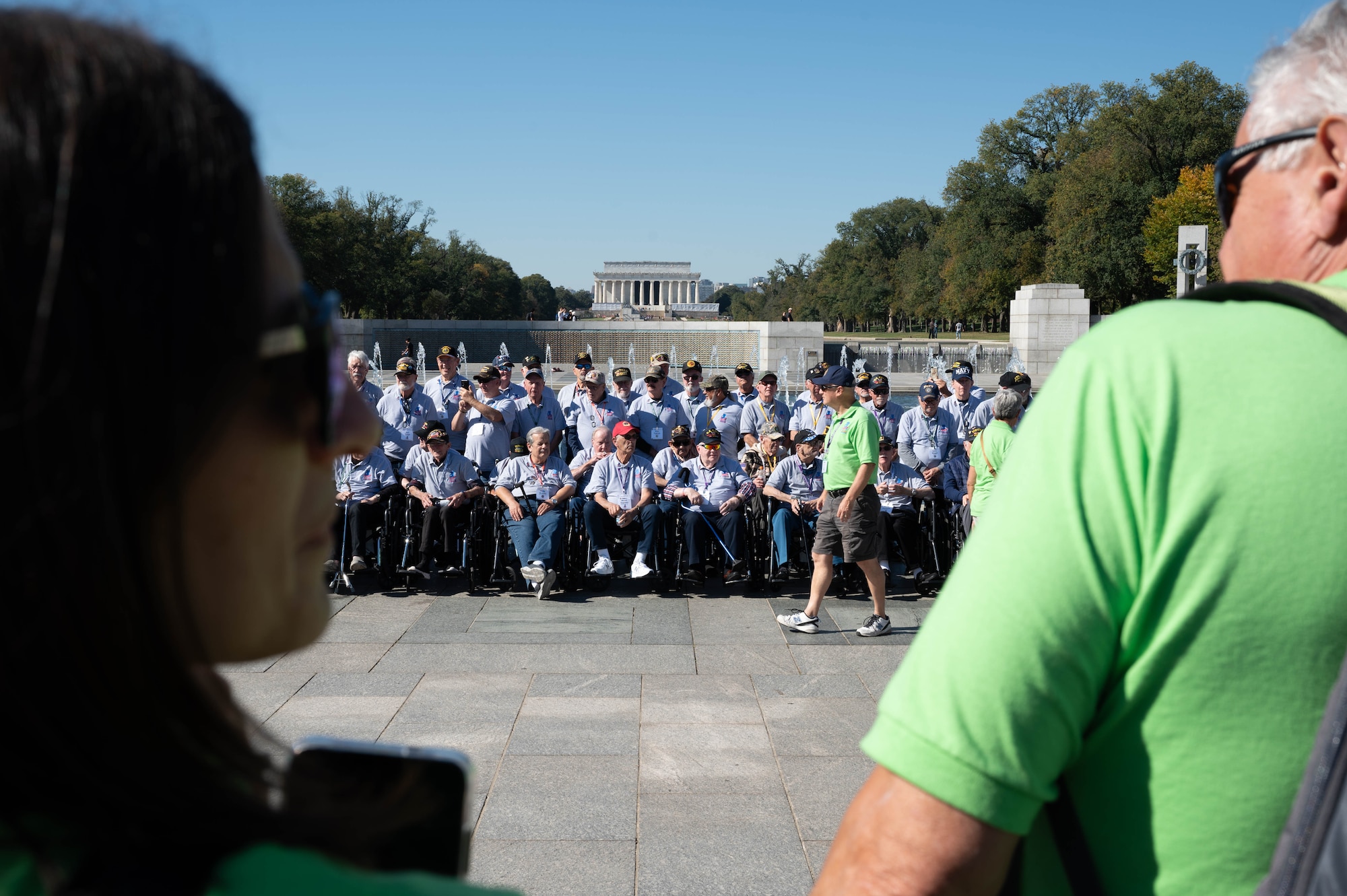 Veterans from Honor Flight Chicago gather together before viewing a Joint Service Color Guard posting of the colors at the World War II Memorial in Washington, D.C., Oct. 23, 2024. The veterans saw the posting of the colors, saluted the American flag for the singing of “The Star-Spangled Banner” and stood for taps, among other portions of the ceremony. (U.S. Air Force photo by Hayden Hallman)