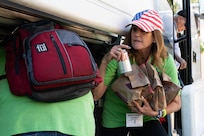 Jenny Brawley, the D.C. Logistics Coordinator for Honor Flight Chicago, prepares the lunch provided to the veterans and volunteers preceding a Joint Service Color Guard posting of the colors at the World War II Memorial in Washington, D.C., Oct. 23, 2024. This trip is provided at no cost to the veteran by Honor Flight Chicago and is intended as a heartfelt thank you for their service and sacrifice. (U.S. Air Force photo by Hayden Hallman)