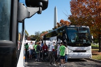 Veterans and volunteers disembark buses at Honor Flight Chicago’s Day of Honor preceding a Joint Service Color Guard posting of the colors at the World War II Memorial in Washington, D.C., Oct. 23, 2024. The Joint Service Color Guard consists of national capital region service members from each branch of the U.S. military. (U.S. Air Force photo by Hayden Hallman)
