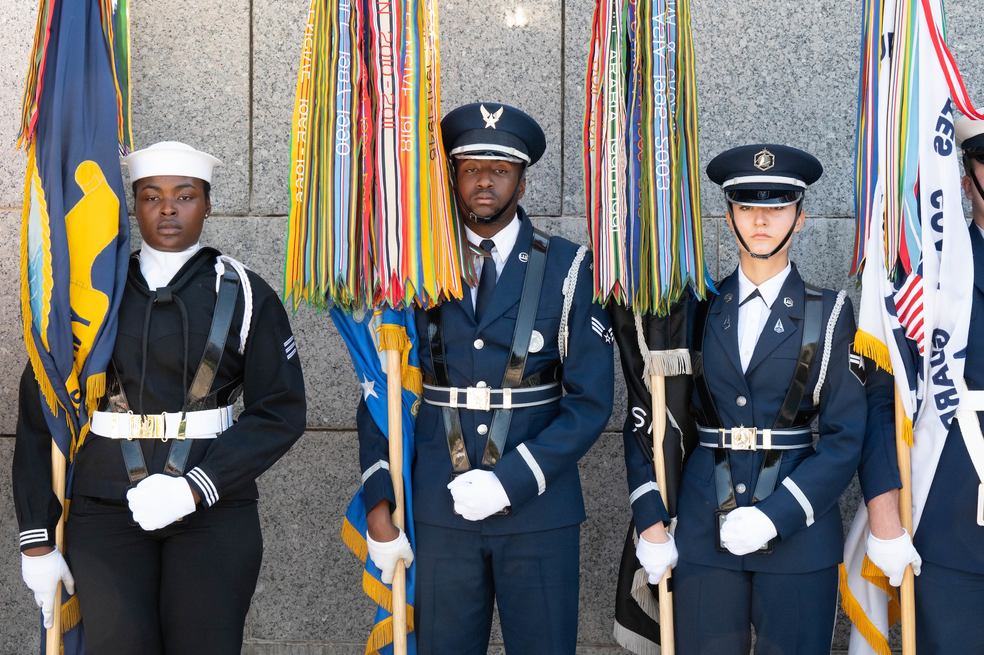 From left to right, U.S. Navy Seaman Jamila Anosike, U.S. Air Force Senior Airman Amani Alexander, and U.S. Space Force Specialist 3 Daisylou Terrone, ceremonial guardsmen, stand at ceremonial at ease following the Joint Service Color Guard posting of the colors at the World War II Memorial in Washington, D.C., Oct. 23, 2024. Anosike, Alexander and Terrone are assigned to Joint Base Anacostia-Bolling, Washington, D.C. (U.S. Air Force photo by Hayden Hallman)