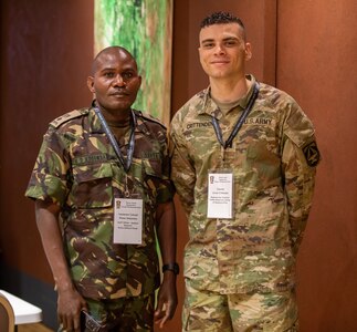 Two men in uniform pose for a photo