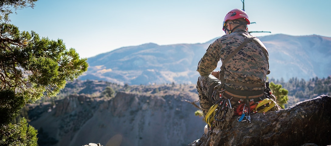 U.S. Marine Corps Sgt. Matthew Casullo, a Westerlo, New York native, mountain warfare instructor for Marine Corps Mountain Warfare Training Center, observes Marines rock climbing up a cliff face during Mountain Leaders Course as part of Mountain Exercise 1-24 at MCMWTC, Bridgeport, California, Oct. 11, 2023. Compared to more generalized training facilities, MCMWTC specializes in mountain warfare training, providing a unique and ideal opportunity to rehearse operations in a mountainous environment. (U.S. Marine Corps photo by Lance Cpl. Richard PerezGarcia)