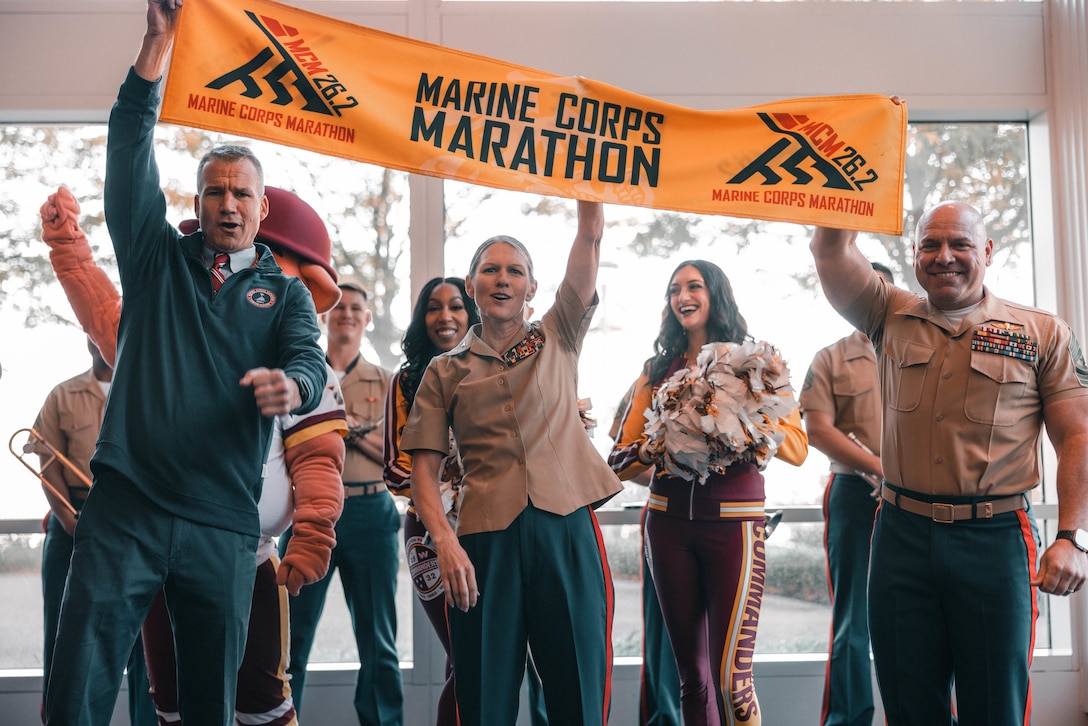 From left, Alex Heatherington, Marine Corps Marathon race director; U.S. Marine Corps Col. Jenny Colegate, the commanding officer of Marine Corps Base Quantico; and Sgt. Maj. Michael Brown, sergeant major of MCBQ, pose for the opening ceremony during the 49th MCM Health & Fitness Expo at the Gaylord National Resort and Convention Center in National Harbor, Maryland, Oct. 25, 2024. The MCM Health and Fitness Expo is the location for participants to pick up MCM race packets. The free expo welcomed participants, family members, friends, supporters, volunteers, and the general public to more than 100,000 square feet of exhibits and booths. (U.S. Marine Corps photo by Lance Cpl. Joaquin Dela Torre)