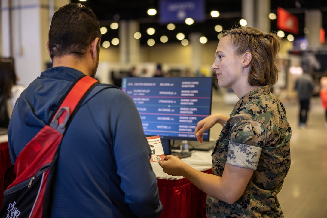 Participants in the 49th Marine Corps Marathon check in during the MCM Health & Fitness Expo at the Gaylord National Resort and Convention Center in National Harbor, Maryland, Oct. 25, 2024. The MCM Health and Fitness Expo is the location for participants to pick up MCM race packets. The free expo welcomed participants, family members, friends, supporters, volunteers, and the general public to more than 100,000 square feet of exhibits and booths. (U.S. Marine Corps photo by Lance Cpl. Joaquin Dela Torre)