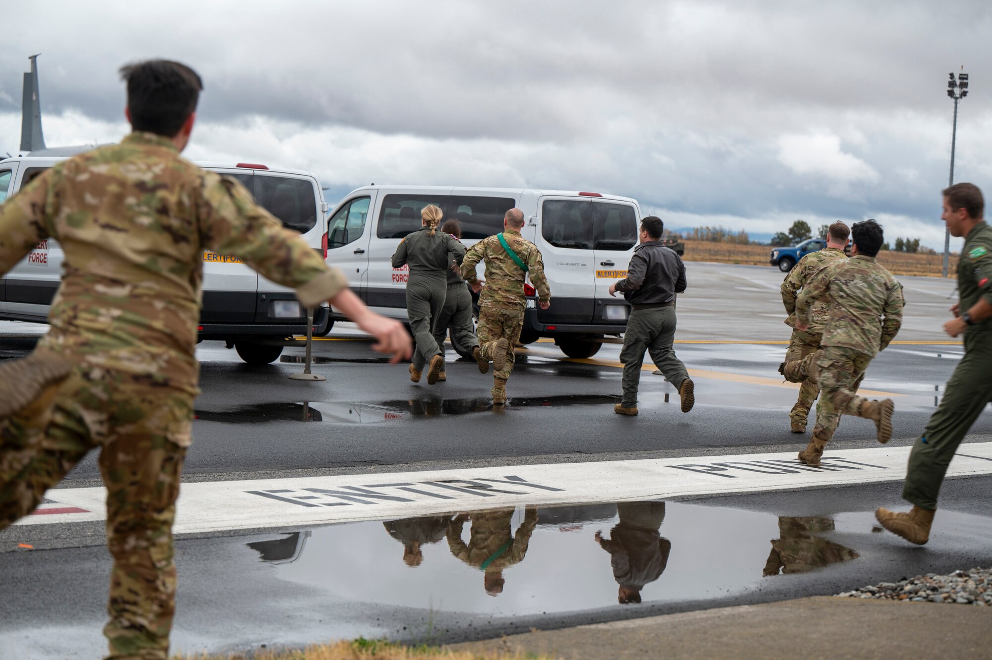 Airmen run to a car