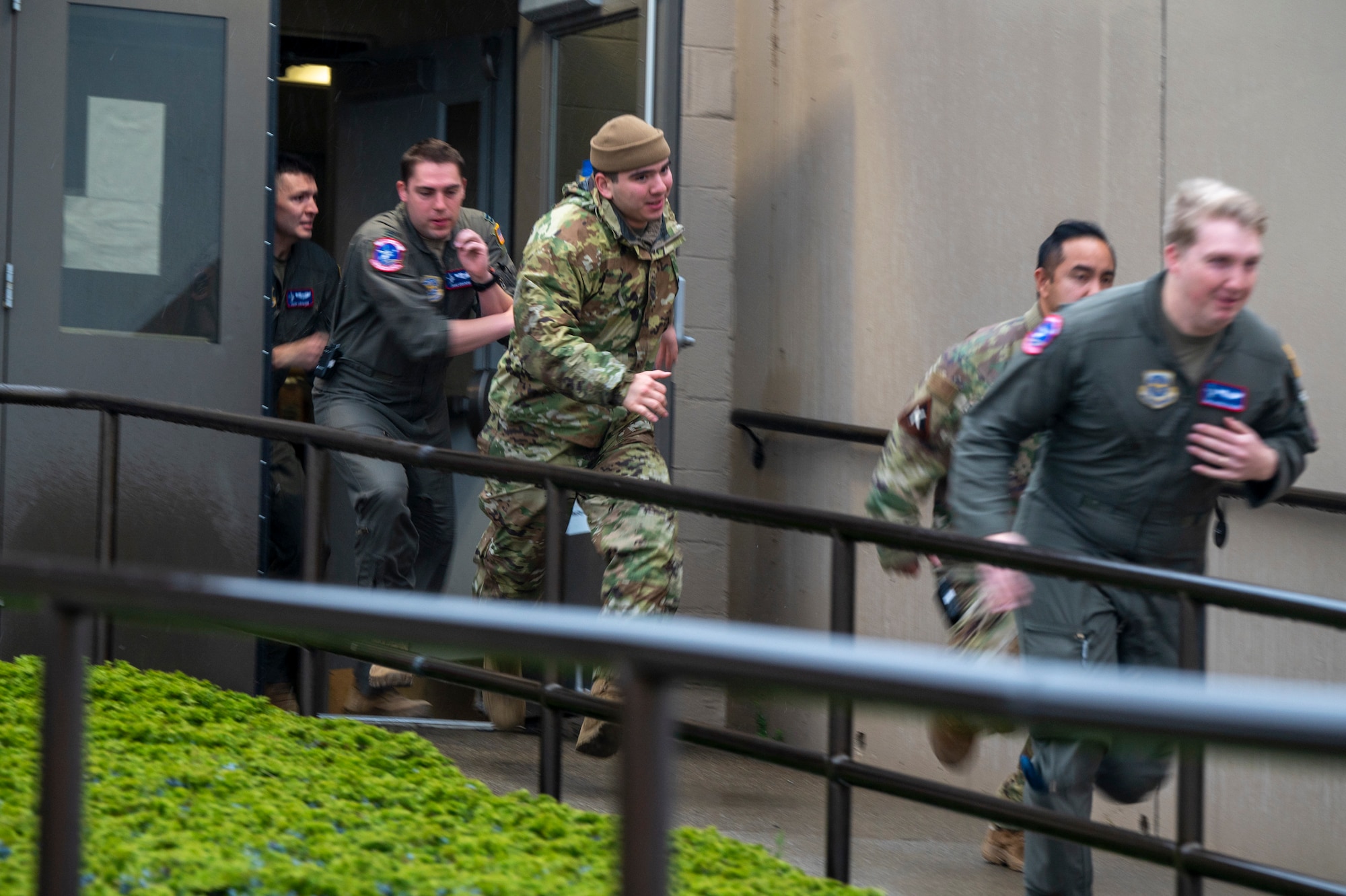 Airmen run out of a building