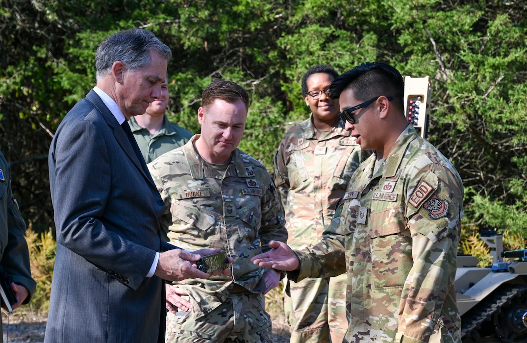 An Airman talks about explosives with a U.S. Representative