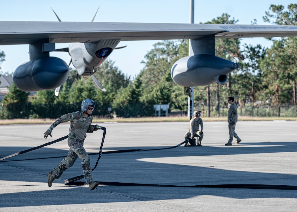 A U.S. Air Force Airman assigned to the 23rd Logistics Readiness Squadron sprints with a fuel hose at Moody Air Force Base, Georgia, Oct. 23, 2024. Forward Area Refueling Point Airmen are able to perform rapid refuel of aircraft in austere conditions. (U.S. Air Force photo by Senior Airman Leonid Soubbotine)