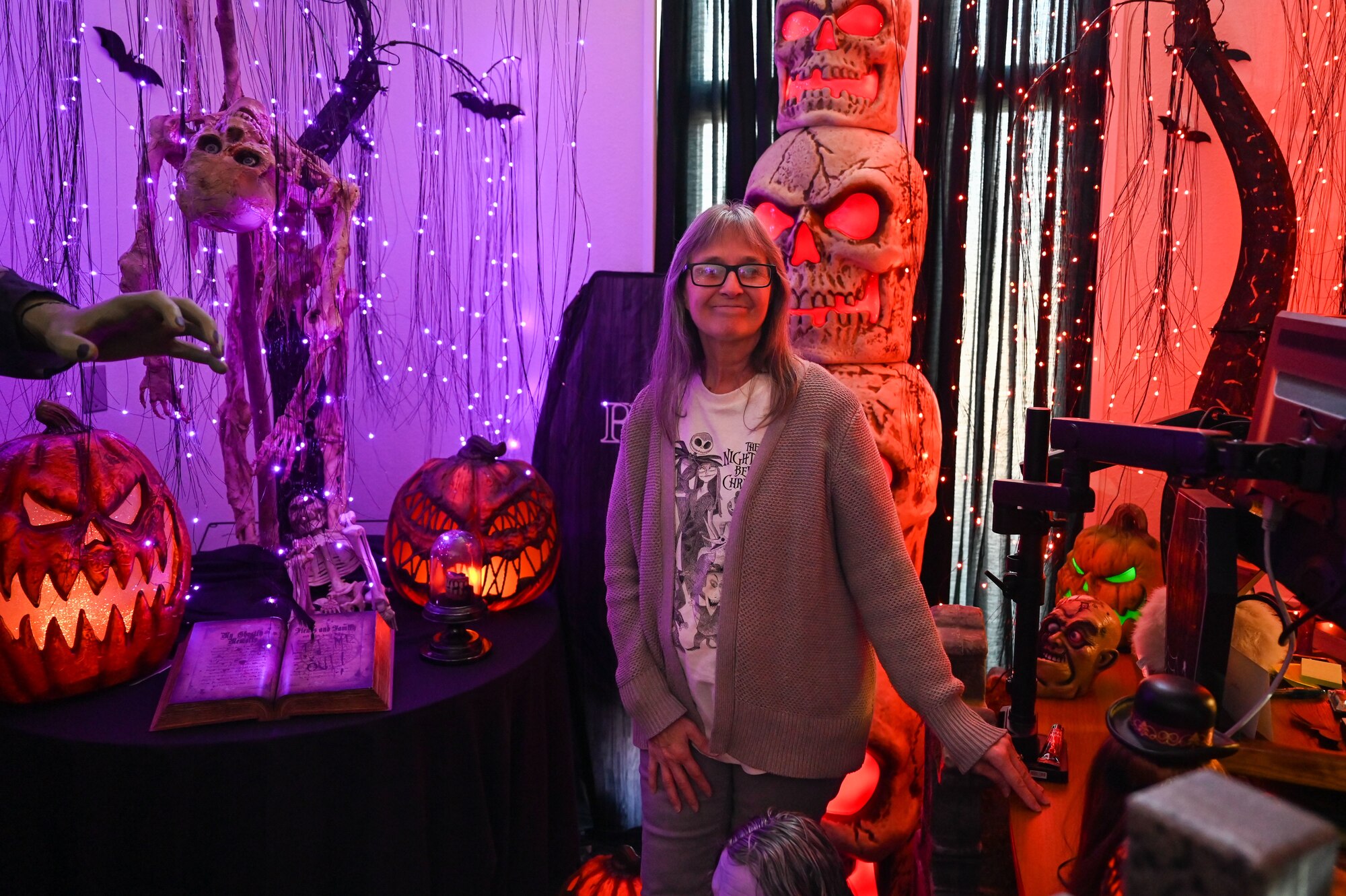 Janice stands in her office posed with halloween decorations.