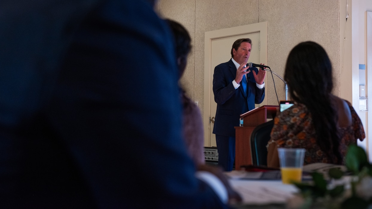 Congressman delivering remarks at podium