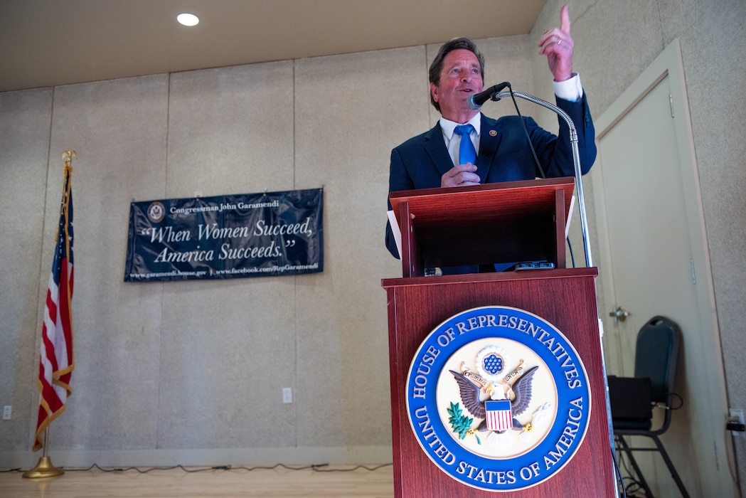 Congressman delivering remarks at podium