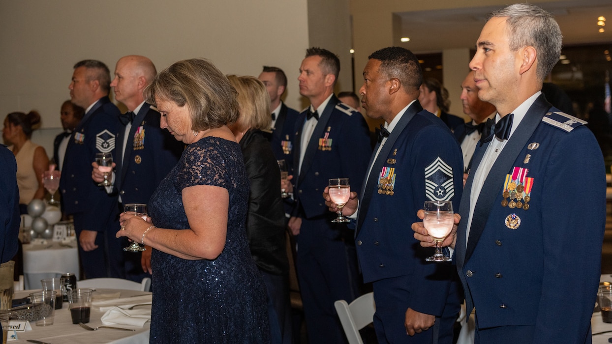 Attendees raising glasses of water in remembrance