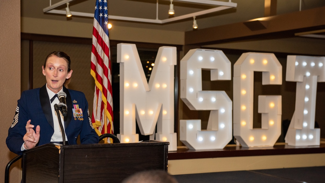 60th AMW command chief deliver remarks at podium