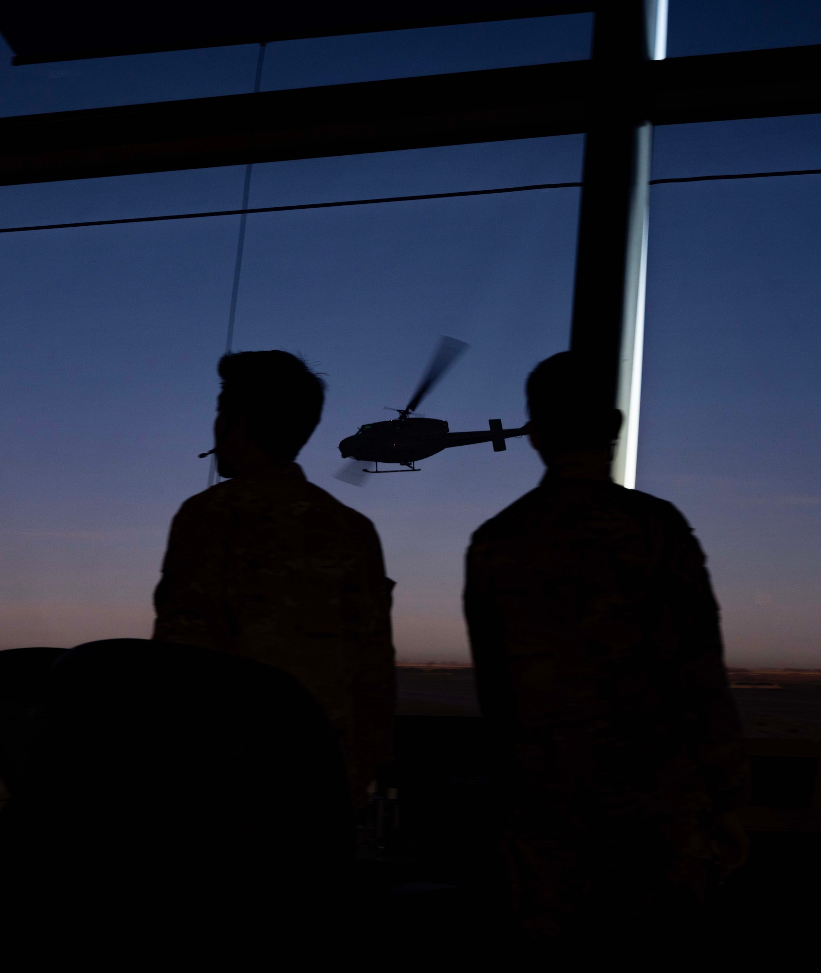 A U.S. Air Force UH-1N Iroquois assigned to the 54th Helicopter Squadron flies by the air traffic control tower during Exercise Global Thunder 25 (GT25) at Minot Air Force Base, North Dakota, Oct. 21, 2024. GT25 enhances integration and interoperability by enabling 5th Bomb Wing Airmen to build enduring relationships necessary to confront a broad range of global challenges. (U.S. Air Force photo by Airman 1st Class Alyssa Bankston)