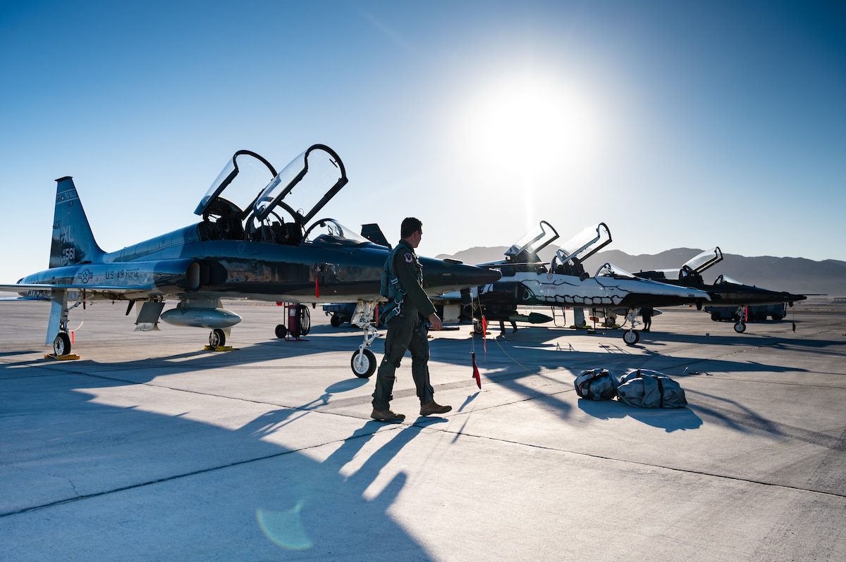 U.S. Air Force Capt. George Frank, a T-38 Talon pilot assigned to the 87th Flying Training Squadron (FTS), Laughlin Air Force Base (AFB), Texas, walks along the flightline at Nellis AFB, Nevada, Sept. 27, 2024. The 87th FTS sent 10 T-38 Talons to Nellis AFB to provide Weapons Instructor Course support for the 6th and 433rd Weapons Squadrons. (U.S. Air Force photo by Airman 1st Class Brianna Vetro)