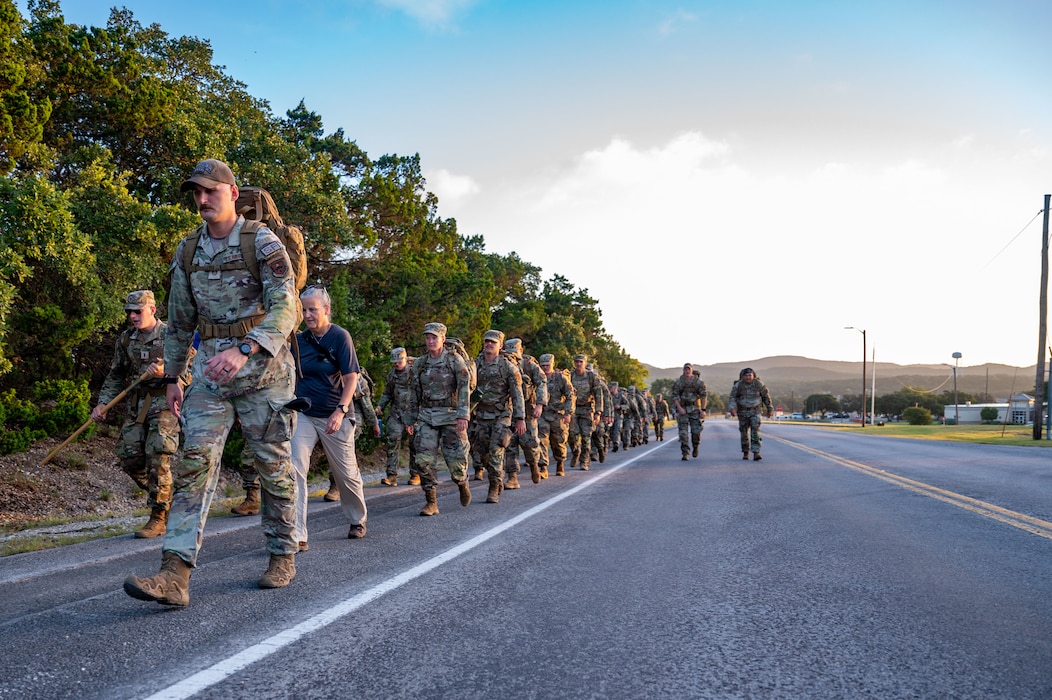 A group of security forces members ruck along roadside