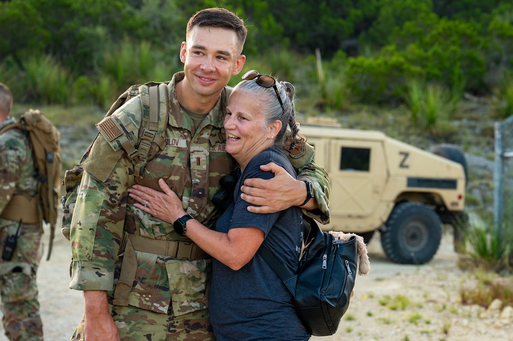 Jiffy Helton-Sarver hugs a security forces officer during the U.S. Air Force Security Forces Basic Officer Course graduation ruck