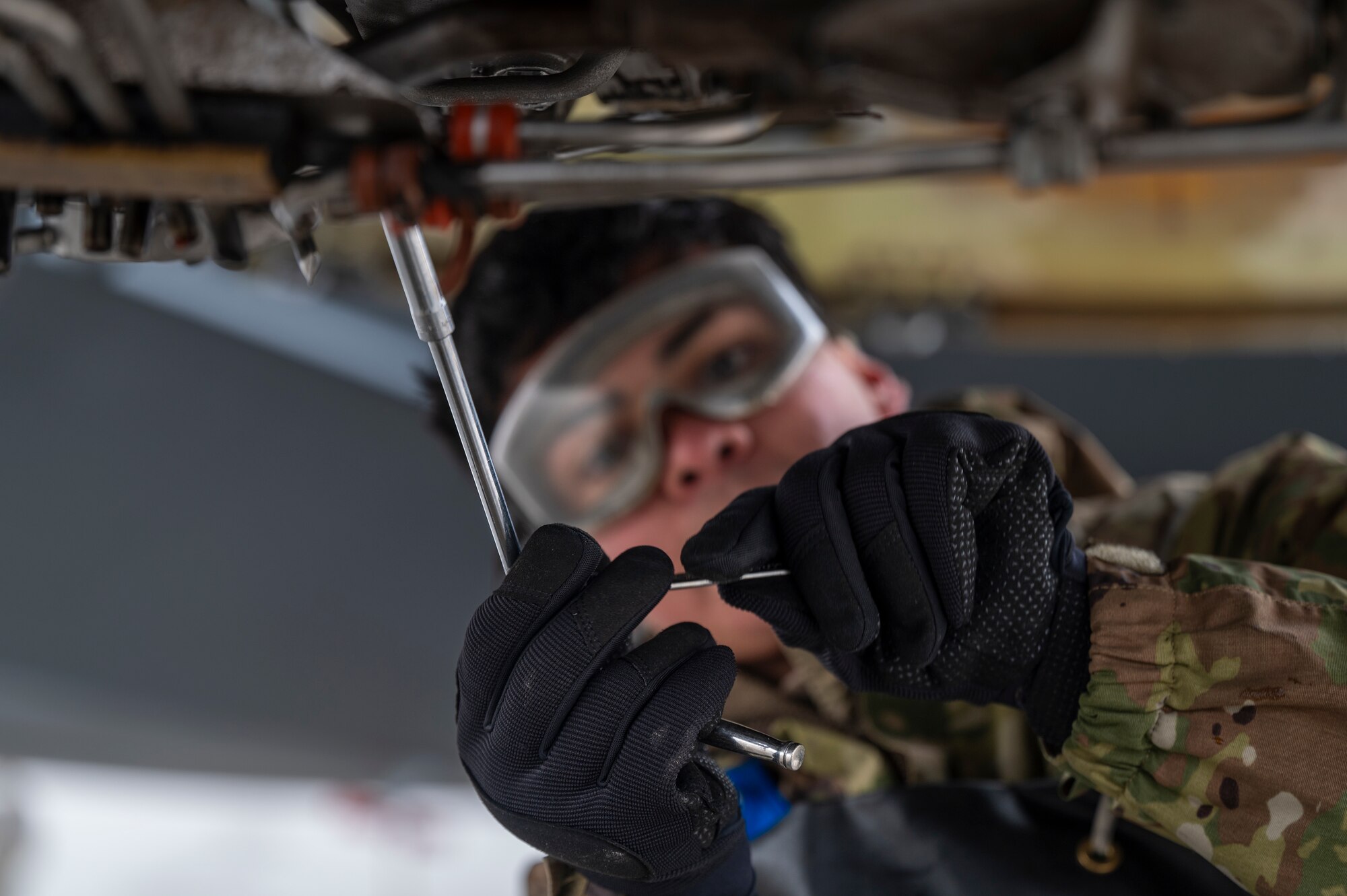 U.S. Air Force Airman Miguel Guerrero, an aerospace propulsion specialist assigned to the 92nd Maintenance Squadron, removes fuel filters during exercise Mobility Response 25 in support of U.S. Strategic Command exercise Global Thunder 25 at Fairchild Air Force Base, Washington, Oct. 23, 2024. Guerrero performed routine maintenance during exercise MR25 to ensure aircraft are fully operational, safe, and ready for critical missions. Executing training exercises like MR25 prepare wings to support the warfighter at the furthest node to ensure light, lean, and distributed operations. (U.S. Air Force photo by Airman 1st Class Stassney Davis)
