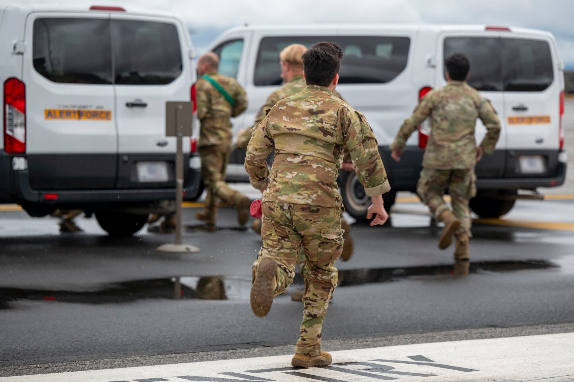 Airmen run to a car