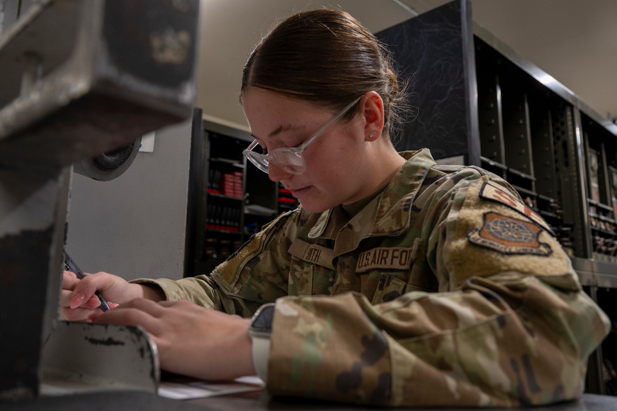 U.S. Air Force Airman 1st Class Lauren Smith, an installation entry controller assigned to the 92nd Security Forces Squadron, issues weapons and equipment during exercise Mobility Response 25 in support of U.S. Strategic Command exercise Global Thunder 25 at Fairchild Air Force Base, Washington, Oct. 20, 2024. As armory personnel, Smith ensured all weapons were accounted for and issued to the correct individuals, allowing security forces to perform their daily tasks. U.S. Strategic Command forces, their components and subordinate units are on watch 24 hours a day, 365 days a year, conducting operations to deter and detect strategic attack against the United States and our allies. (U.S. Air Force photo by Airman 1st Class Samantha Thorn)