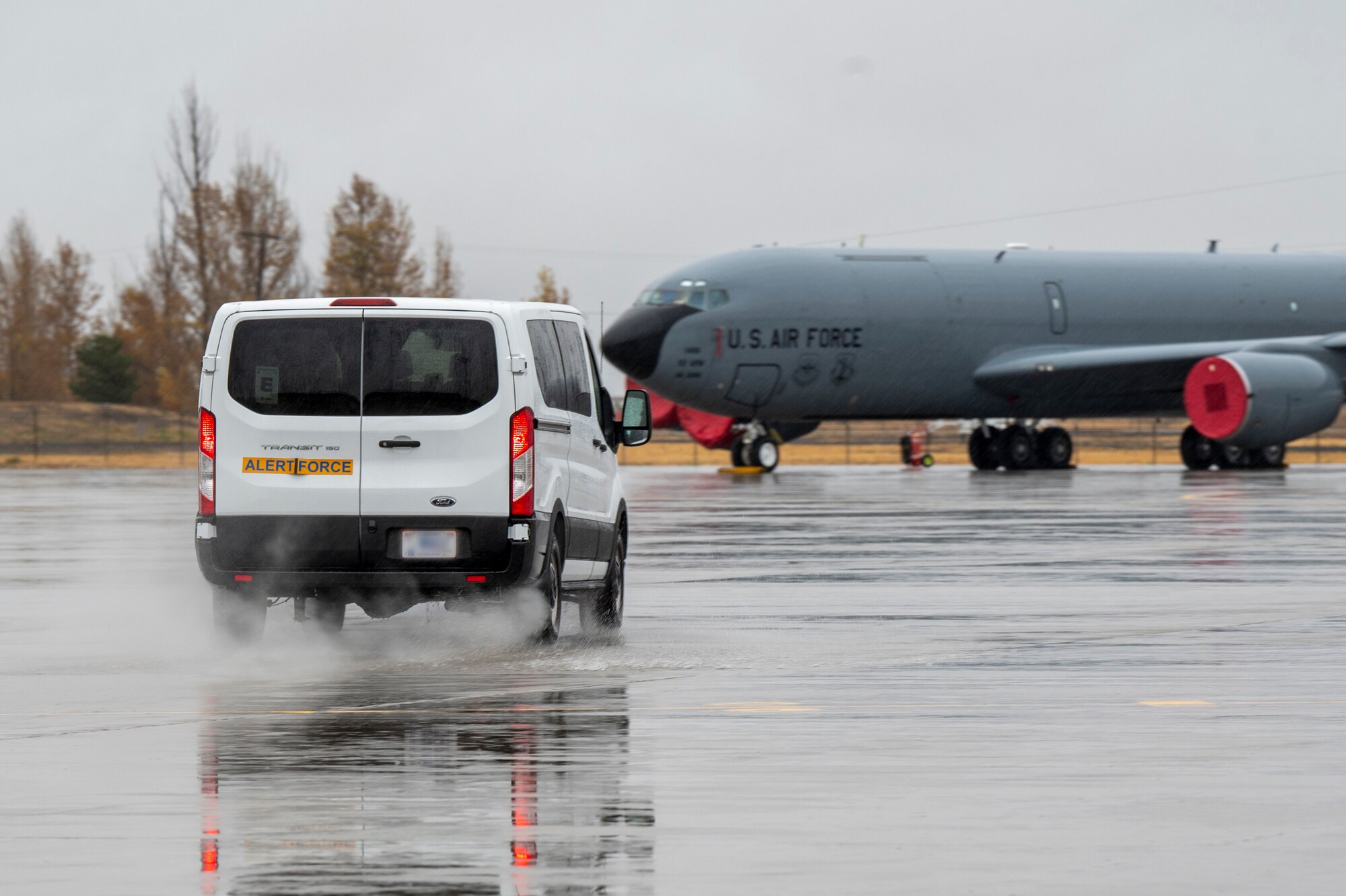 A vehicle drives on the flightline