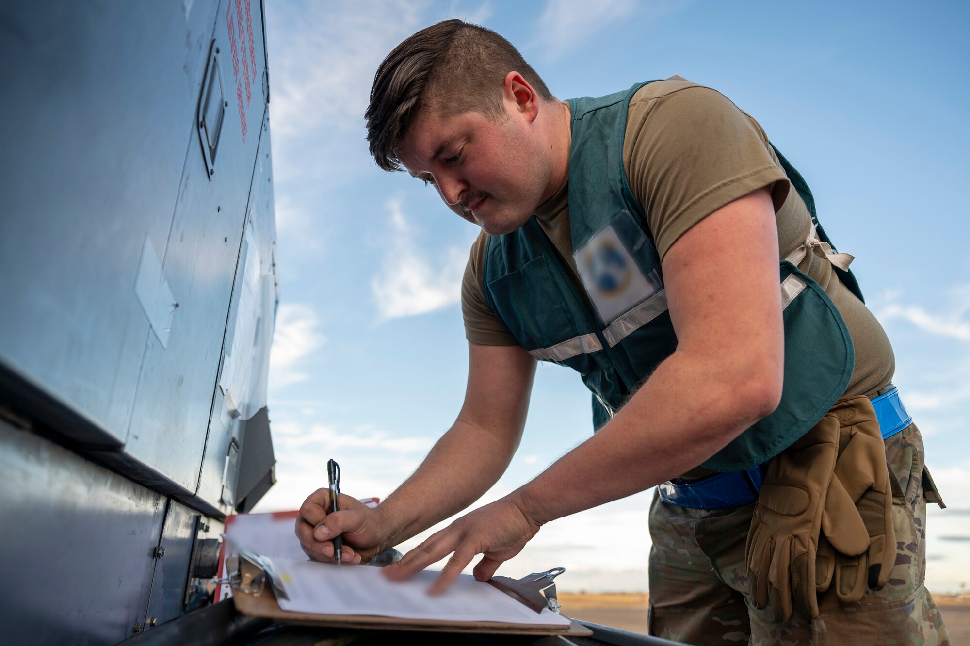 An Airmen fills out paperwork