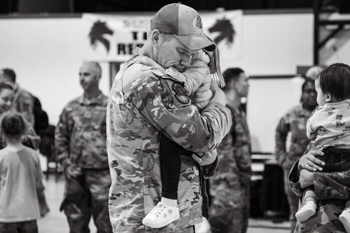 Uniformed personnel stand together in a photo.