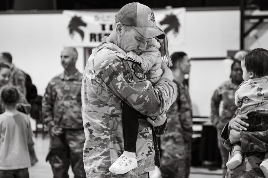 Uniformed personnel stand together in a photo.