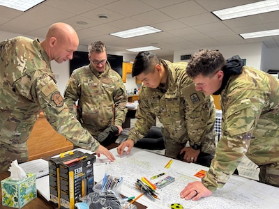 Members of the Alaska Organized Militia assigned to Joint Task Force Kotzebue review community maps to determine damage assessment priority routes in the Arctic Circle community of Kotzebue, Oct. 26, 2024. The team’s assessments and reports will help local emergency managers determine supplies needed to repair and rebuild structures impacted by severe flooding along Alaska’s West Coast. The 11-member team, including personnel from the Alaska Air and Army National Guard and the Alaska State Defense Force, was activated by the State Emergency Operations Center to support response and recovery efforts.