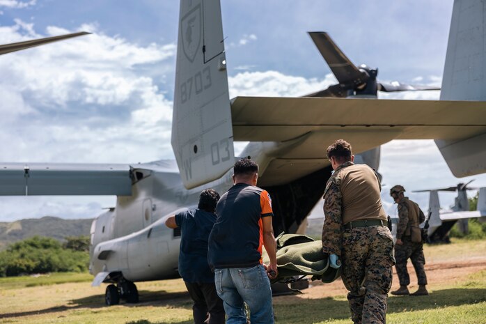 U.S. Navy Hospital Corpsman 2nd Class David Doyle, a preventative medical technician with Marine Rotational Force-Southeast Asia, and members of the Philippine Bureau of Fire Protection, carry a simulated casualty while conducting a humanitarian aid and disaster relief demonstration during KAMANDAG 8 at Camp Cape Bojeador, Burgos, Philippines, Oct. 20, 2024. KAMANDAG is an annual Philippine and U.S. Marine Corps-led exercise aimed at enhancing the Armed Forces of the Philippines’ defense and humanitarian capabilities by providing valuable training in combined operations with foreign militaries in the advancement of a Free and Open Indo-Pacific. This year marks the eighth iteration of this exercise and includes participants from the French Armed Forces, Royal Thai Marine Corps, and Indonesian Marine Corps; including continued participation from the Australian Defense Force, British Armed Forces, Japan Ground Self-Defense Force, and Republic of Korea Marine Corps. MRF-SEA is a rotational unit derived from elements of I Marine Expeditionary Force executing a U.S. Marine Corps Forces, Pacific operational model that involves training events and exchanges with partner military subject matter experts, promotes security goals with Allied and partner nations, and ensures a persistent I MEF presence west of the International Date Line. (U.S. Marine Corps photo by Sgt. Shaina Jupiter)